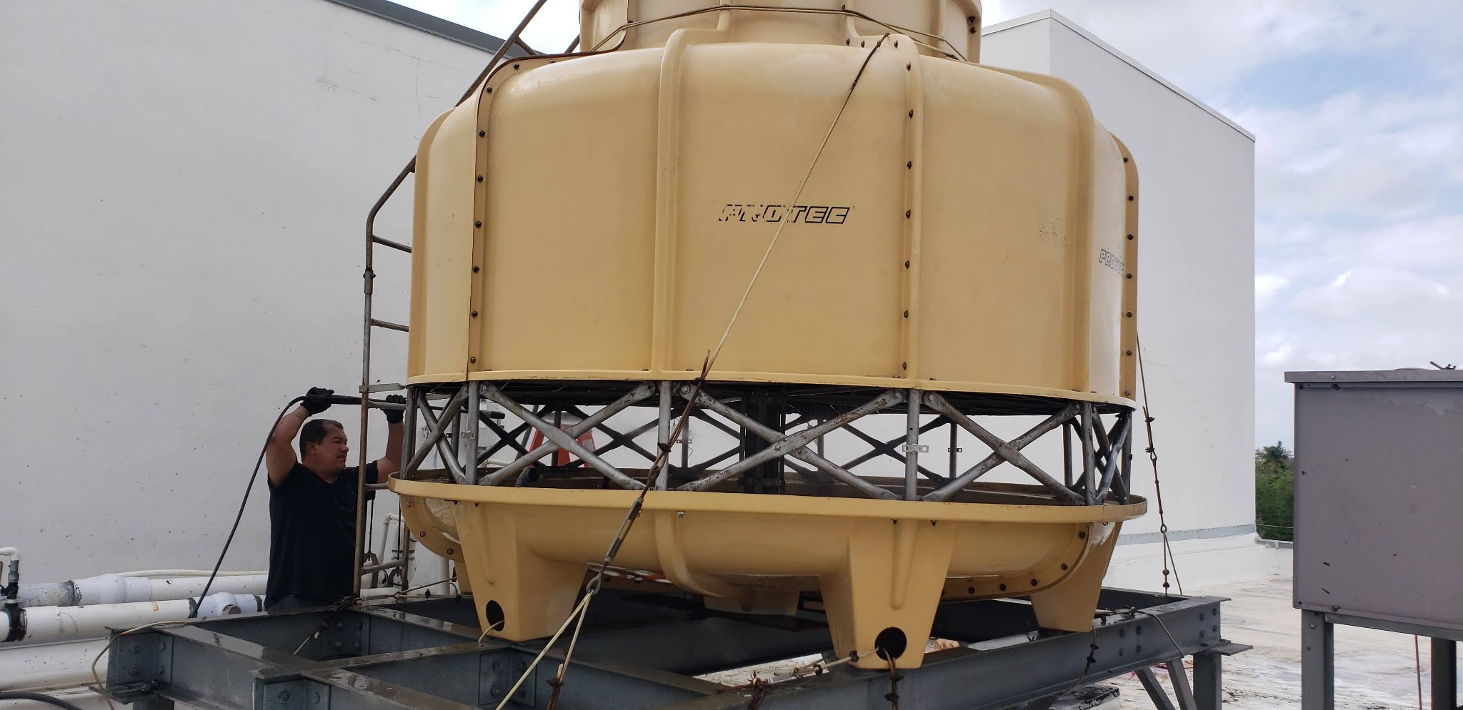 Technician servicing commercial cooling tower equipment