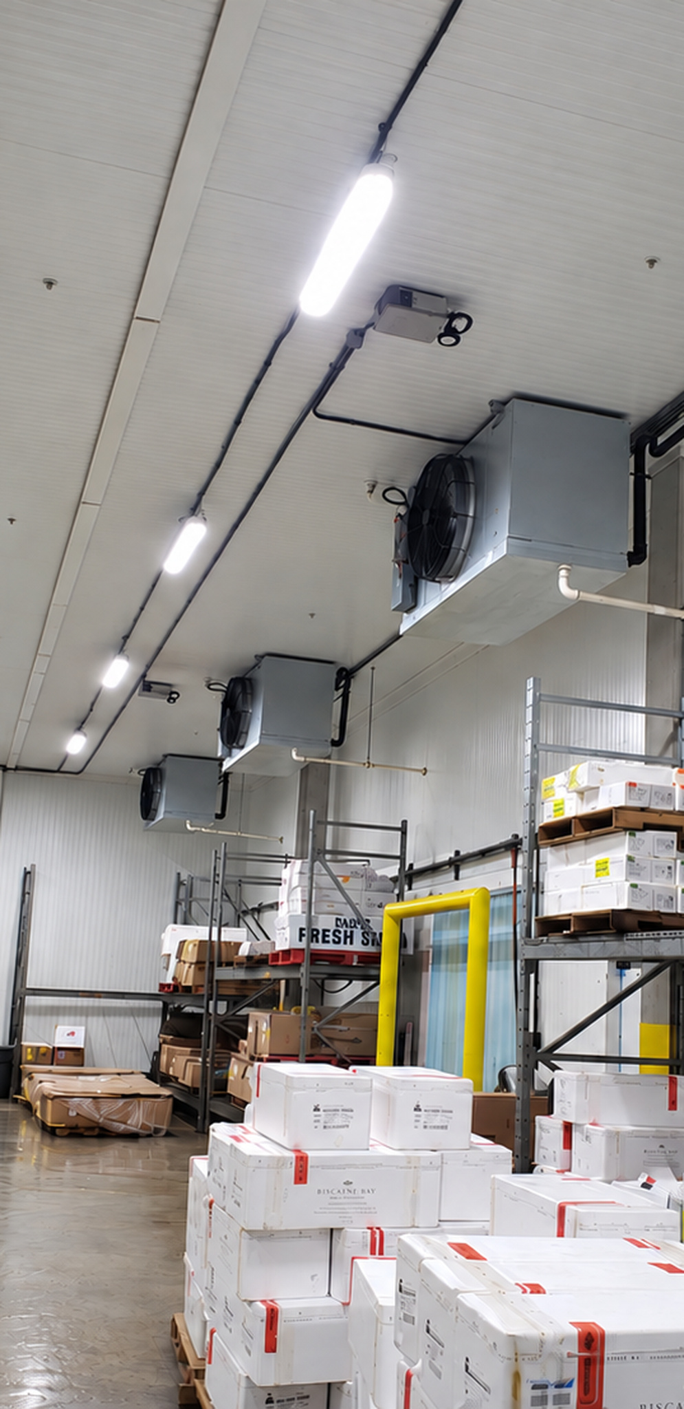 Row of commercial refrigeration unit coolers installed in a cold-storage facility