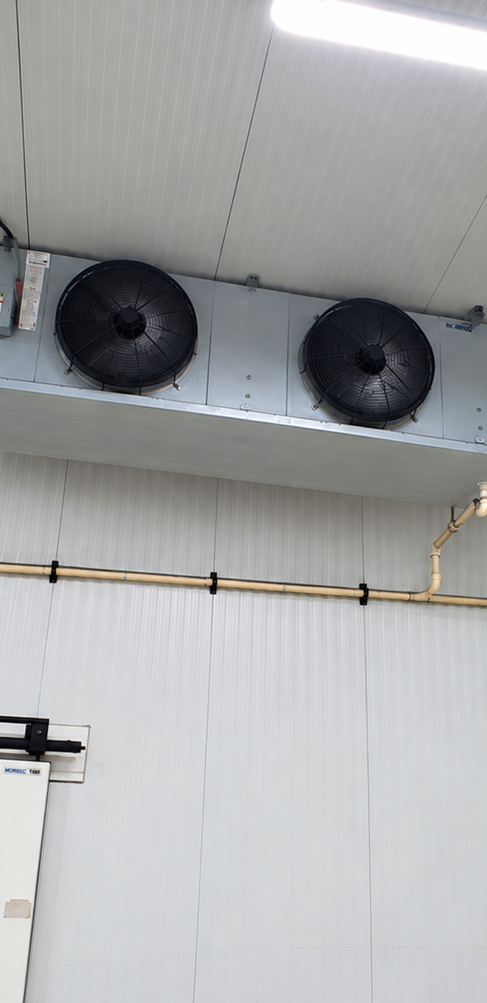 Close view of a commercial two-fan refrigeration unit cooler