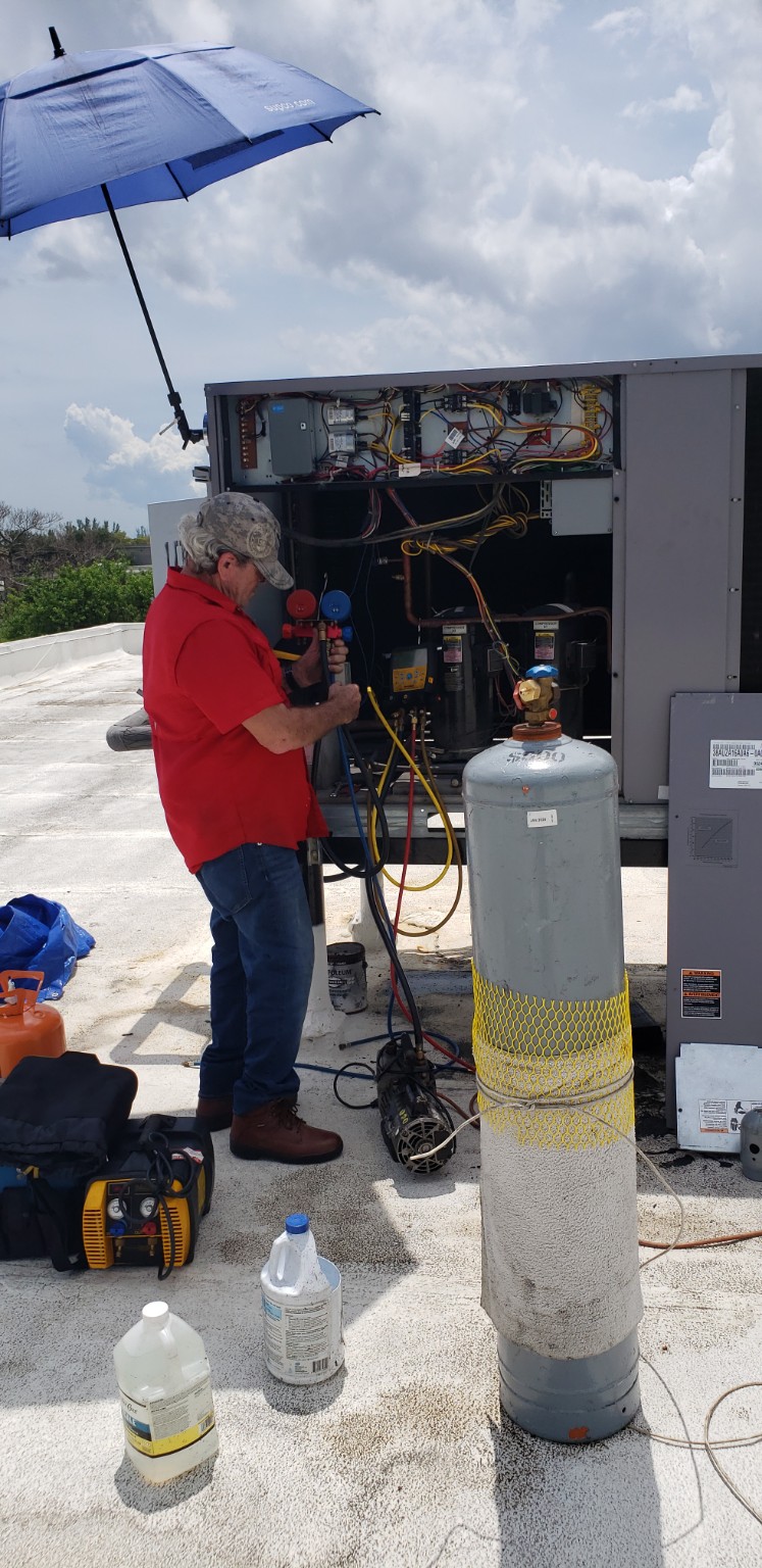 4 Seasons technician performing a commercial refrigeration system retrofit and refrigerant charging